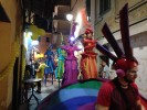 Rainbow parade on stilts by colorful stilt walkers