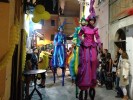 Rainbow parade on stilts by colorful stilt walkers