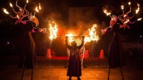 Fire show with stilt walkers