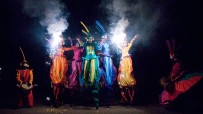 Rainbow parade on stilts by colorful stilt walkers