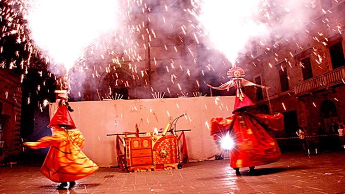 Fire show with stilt walkers