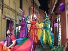 Rainbow parade on stilts by colorful stilt walkers