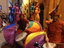 Rainbow parade on stilts by colorful stilt walkers