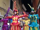 Rainbow parade on stilts by colorful stilt walkers