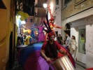 Rainbow parade on stilts by colorful stilt walkers