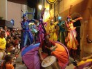 Rainbow parade on stilts by colorful stilt walkers